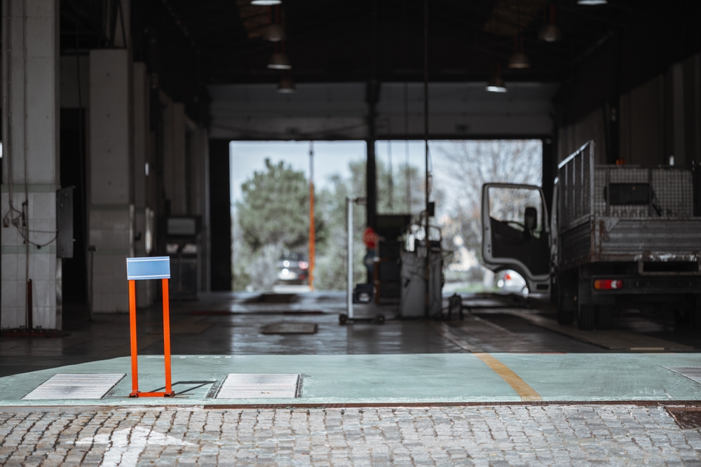 Commercial garage door repair solutions for business security with technician servicing industrial door system