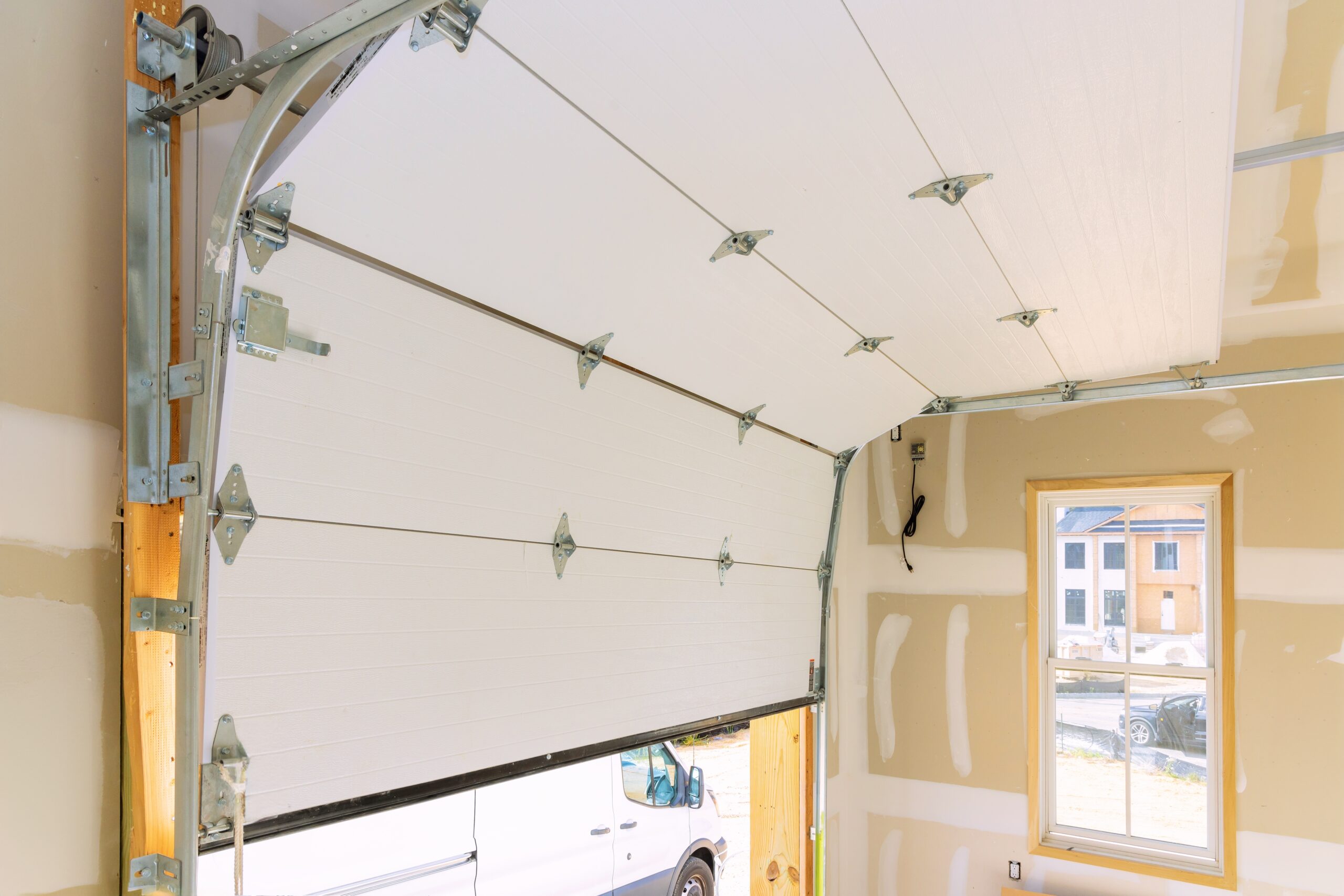 technician following complete guide to garage door installation during setup