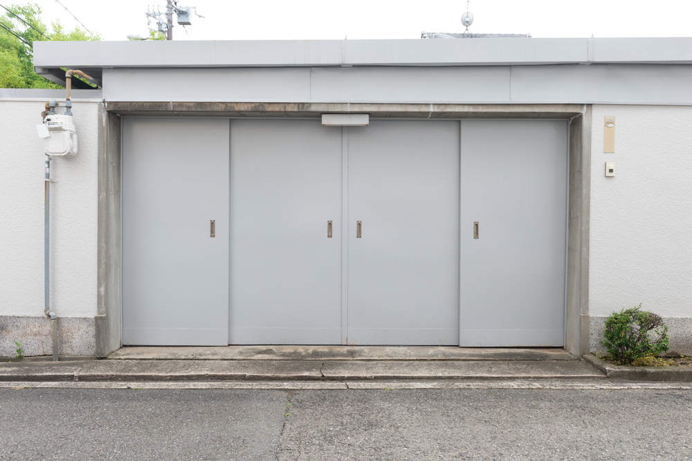 technician performing garage door replacement that improves strength and movement