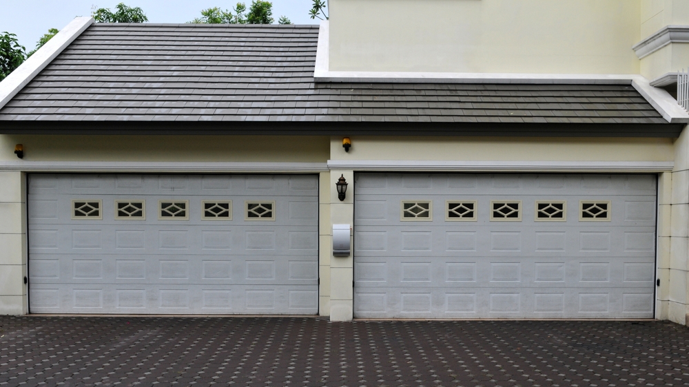 Modern home showcasing custom garage door design ideas with sleek architectural finishes