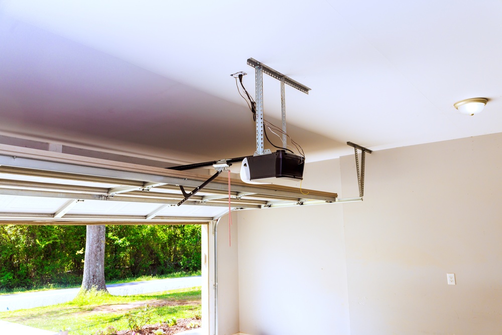 Professional technician explaining garage door installation cost and installation process to homeowners