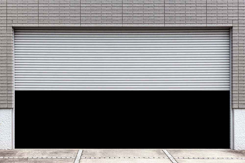Homeowner checking a garage door opener troubleshooting issue in a residential garage