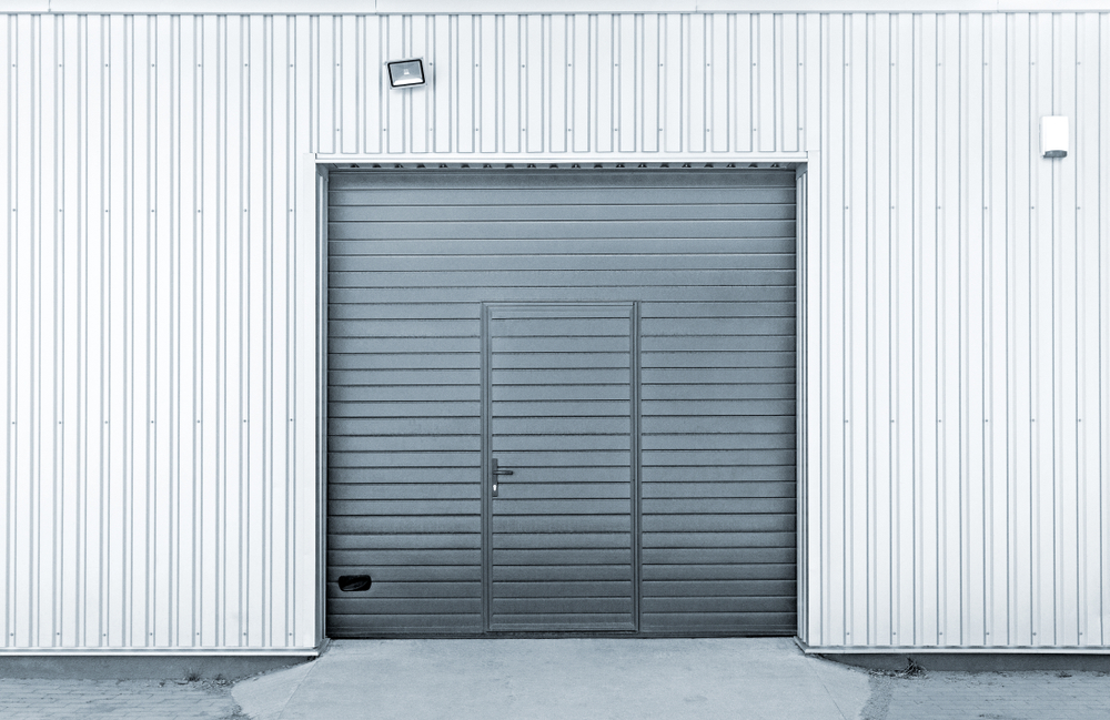 Modern garage door with safety sensors helping protect children in a residential driveway