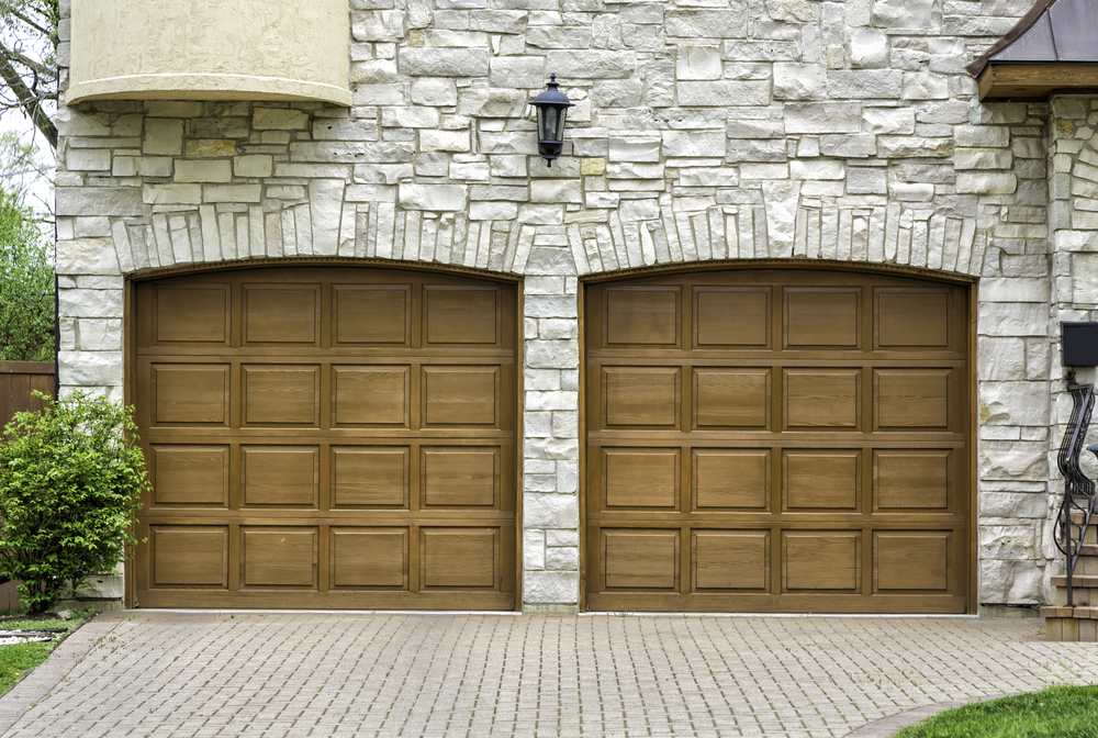 Comparison of traditional garage doors on a historic home and contemporary garage doors on a modern home